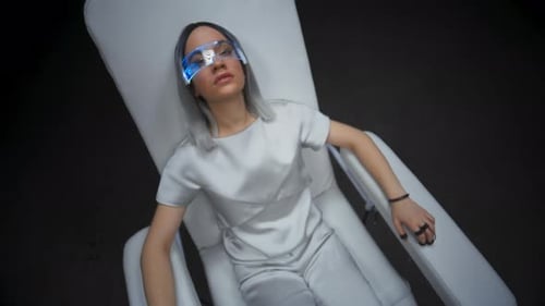 Woman Lying in Medical Chair with Futuristic Glasses