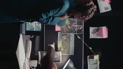 Adults Reviewing Evidence on Crime Board