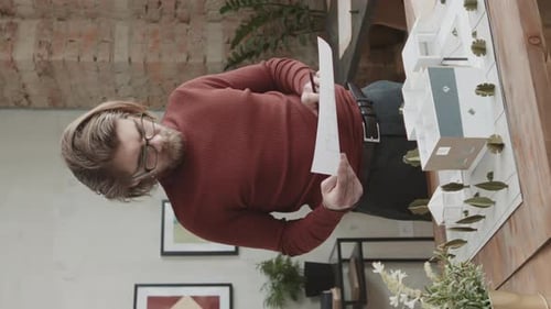 Architect Examining Plans and Building Model