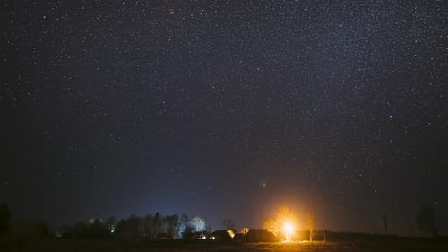 Real Night Sky Stars Above Old Village. Natural Starry Sky Above Rural Countryside Landscape In