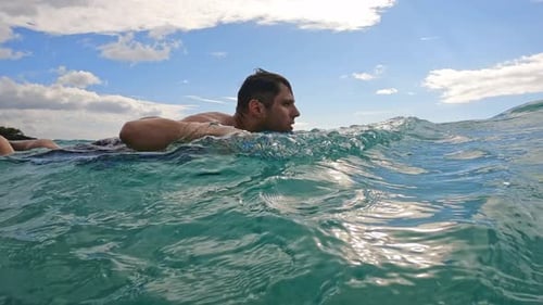 Man Swimming with Bodyboard in Turquoise Ocean Water