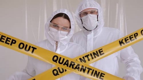 People in Protective Suits Behind Quarantine Tape