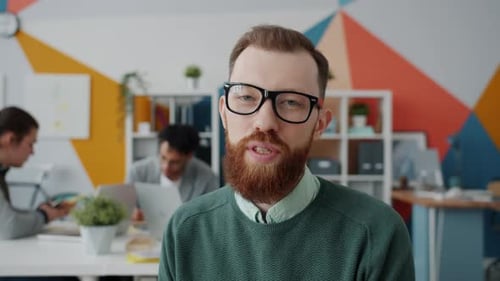 Portrait of Attractive Office Worker Talking and Gesturing During Online Video Call at Work