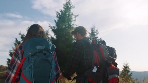 Hikers with Backpacks Hike on Mountain Trail