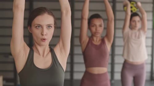 Women Lifting Weights in a Gym