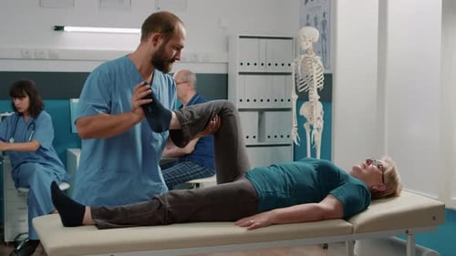 Physical Therapist Manipulates Woman's Leg