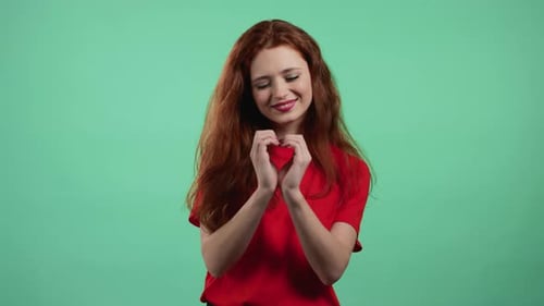 Smiling Woman Making Heart Shape with Hands