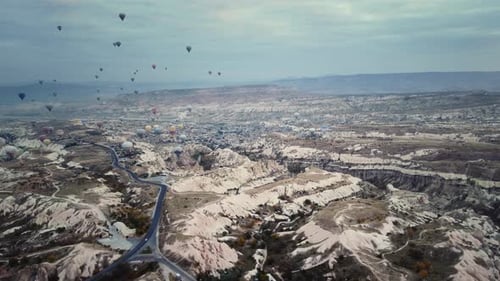 Aerial Drone View of Flying Hot Air Balloons Over Valley with Limestone Hills and Canyons