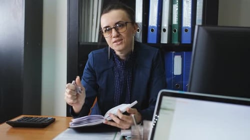 Rack Focus on Woman From Human Resource Department Interviews a Potential Employee in the Office