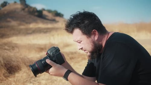 Bearded Man Taking Photos Outdoors in Field