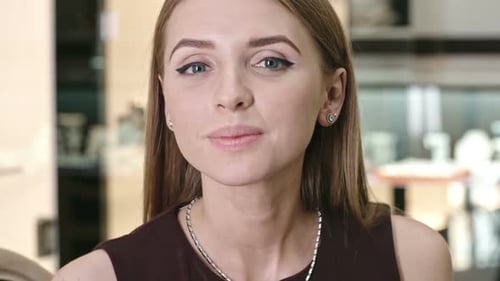 Woman Trying On Earrings in Store