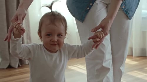 Woman Teaching Kid How to Walk