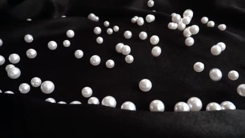 Pearls Falling onto Black Velvet