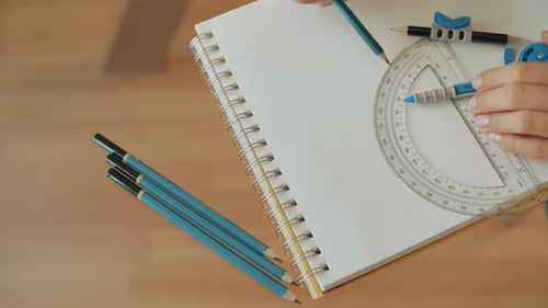Hands use Protractor and Pencil for Drawing