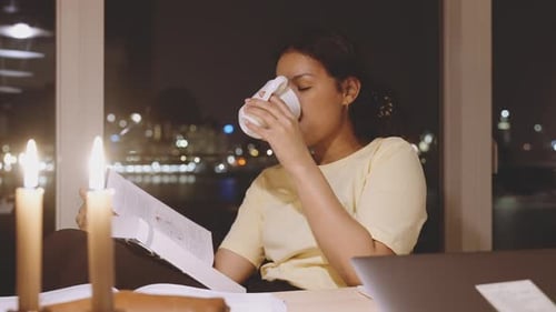 Student Studying And Drinking Coffee At Night