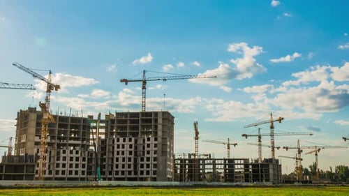 Construction Cranes at Building Site on Sunny Day
