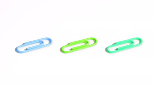 Colorful Paper Clips are Spinning on a White Background