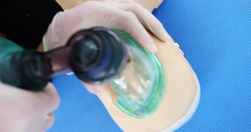 Practicing CPR on Medical Mannequin with Ventilation Mask