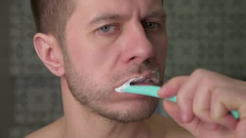 Close Up Man Cleaning Teeth