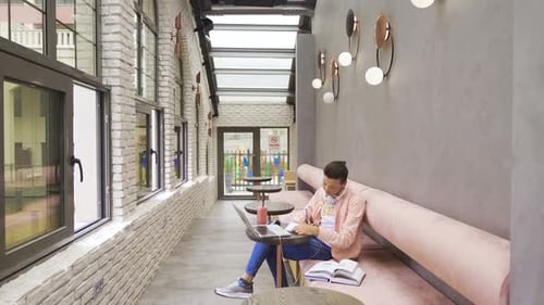 Handsome student studying in cafe.
