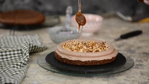 Pastry Chef Is Pouring Caramel On Chocolate Sponge Cake, Making Cake In Bakery