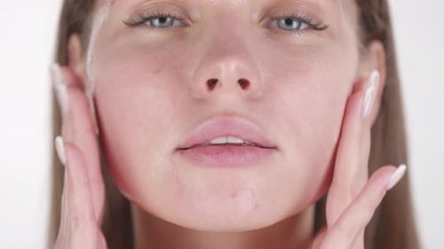 Woman Applies Skin Product to Face