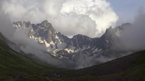 High Snowy Mountains on the Background of Glacial U Valley and Alpine Meadows