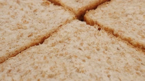 Four pieces of complete bread made of full grain close-up 4K 2160p 30fps UltraHD tilting footage -