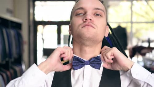 Fashionable Glamorous Man Chooses Clothes in the Store. Portrait of a Businessman with Dreadlocks