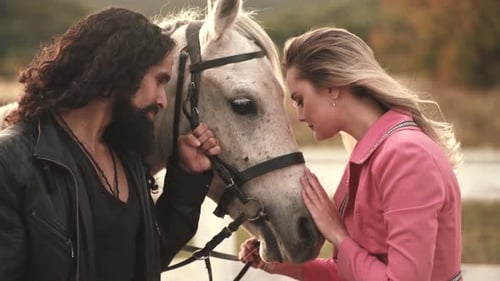 Young Couple with Their Horse. Charming Young Lovers Stands with a Horse. Country in the Rays of