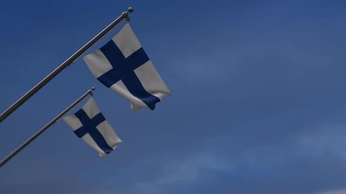 Finland Flags Waving Proudly Against Blue Sky