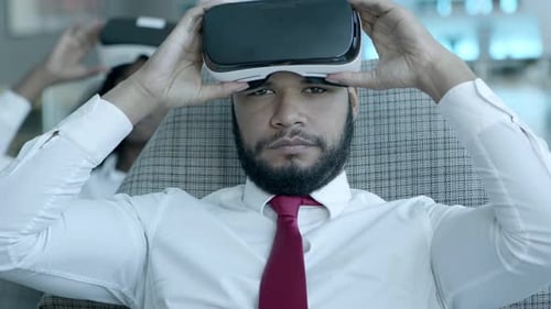 Man Puts On VR Headset in Office Setting