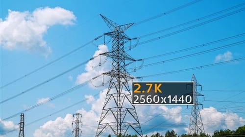 Power Lines and Pylons Against Blue Sky
