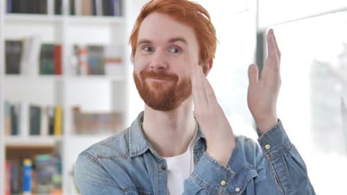 Man Enthusiastically Clapping Hands Indoors