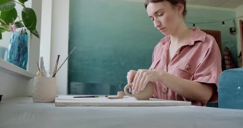 Woman Handcrafting Clay Mug in Studio