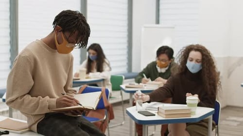 Students Wearing Masks Studying in a Classroom