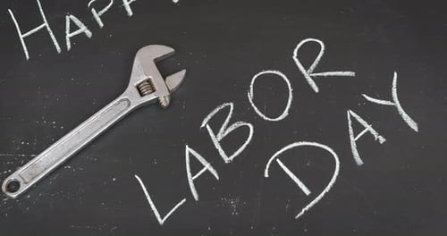 Happy Labor Day with Wrench on Black Background