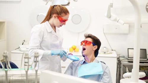 Man Receiving Dental Treatment from Dentist