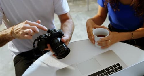 People Working Together in Modern Studio with Camera