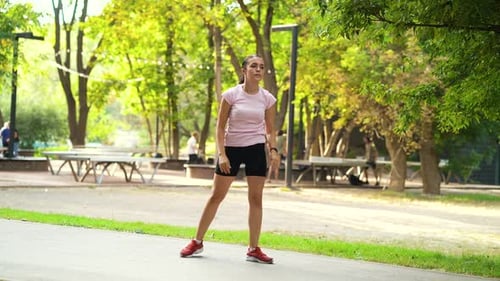 Woman in Sportswear Doing Exercises in Park