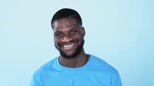 Smiling Young Man in Blue Shirt Portrait