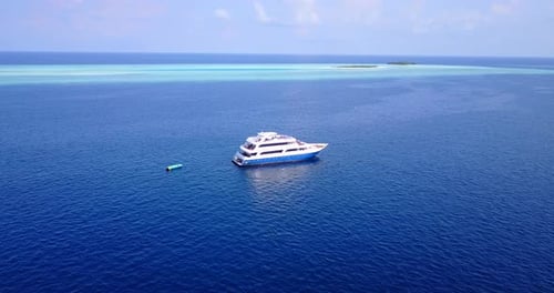 Luxury fly over copy space shot of a sunshine white sandy paradise beach and aqua blue water backgro