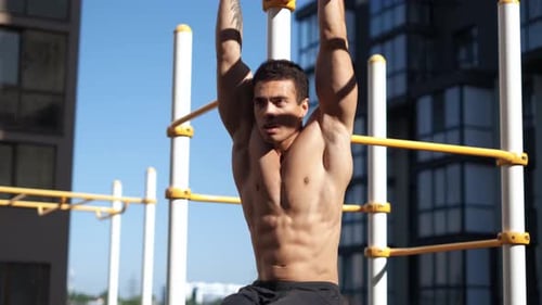 Young Muscular Man Has the Training Outdoors. Sport, Fitness, Street Workout Concept