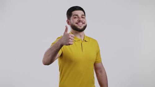 Smiling Man Gives Thumbs Up on White Background