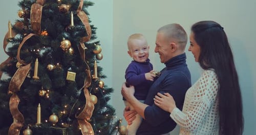 Family Decorates Christmas Tree Together Indoors