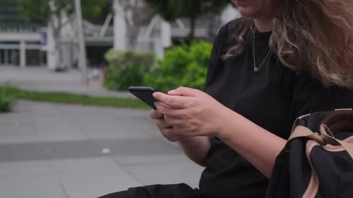 Woman Is Using Smartphone Outdoors in City