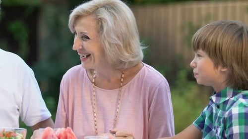 Grandparents and Grandchildren Enjoying Summer Outdoor Meal