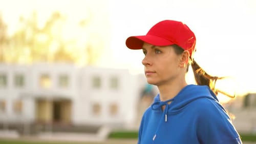 Woman Runs Through the Stadium at Sunset
