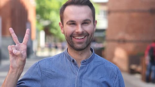 Man Smiles and Gestures Peacefully in City