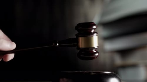 Judge is Hitting Gavel Off a Block in Courtroom